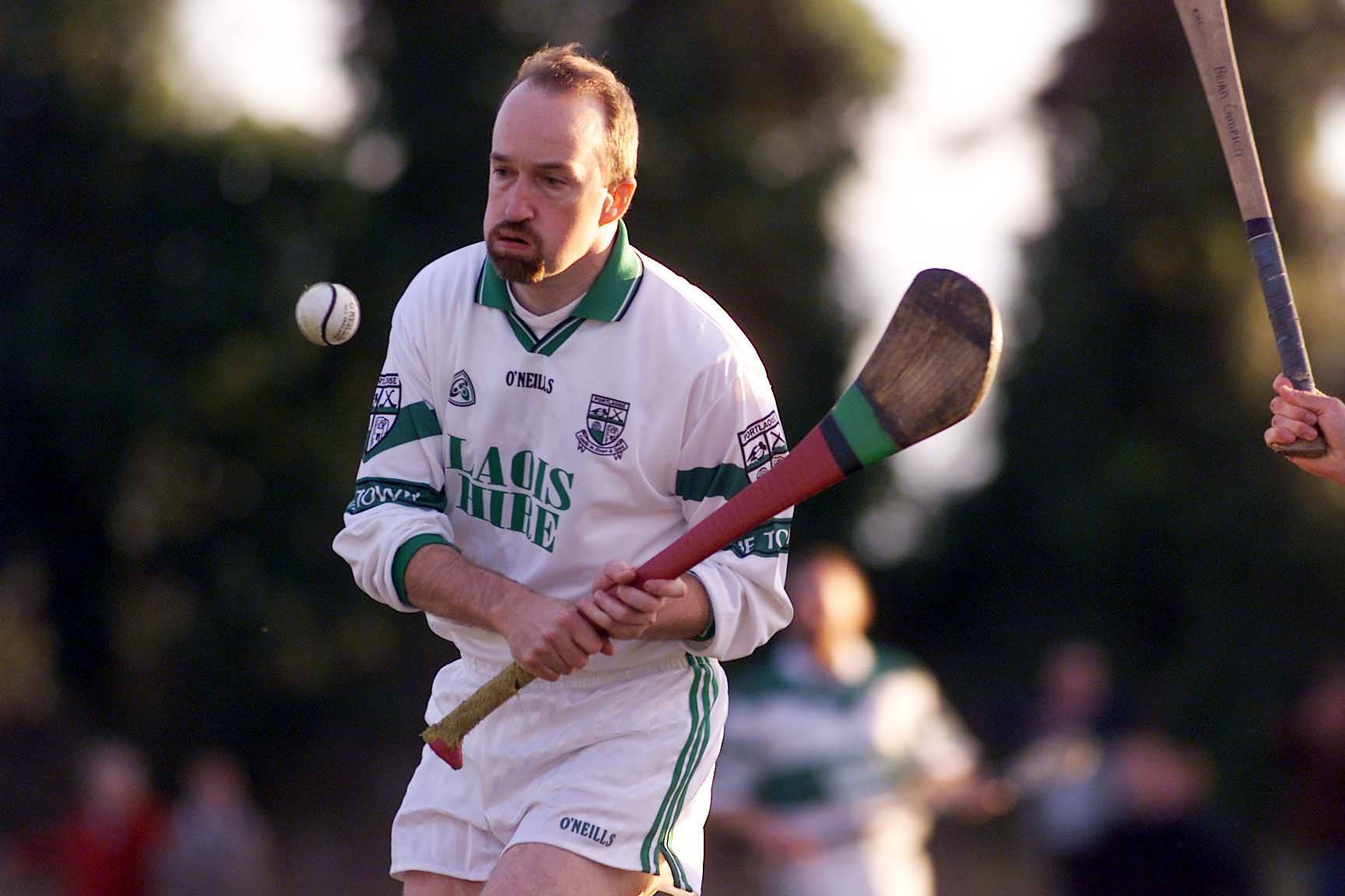 Portlaoise goalie John "Hanno" Hanniffy bursts out of the defense with the ball helped by Joe Phelan and Brian Mulligan